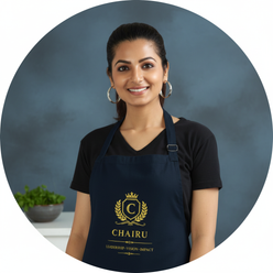 Circular portrait of Kavya Nair, a South Asian woman, smiling while wearing a natural canvas-colored cotton drill apron in a 